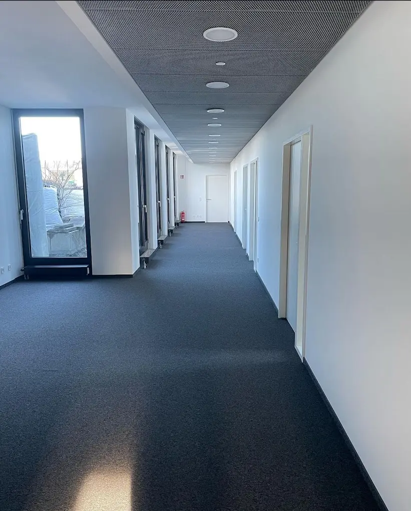 Circulation corridor with acoustic ceiling and carpet