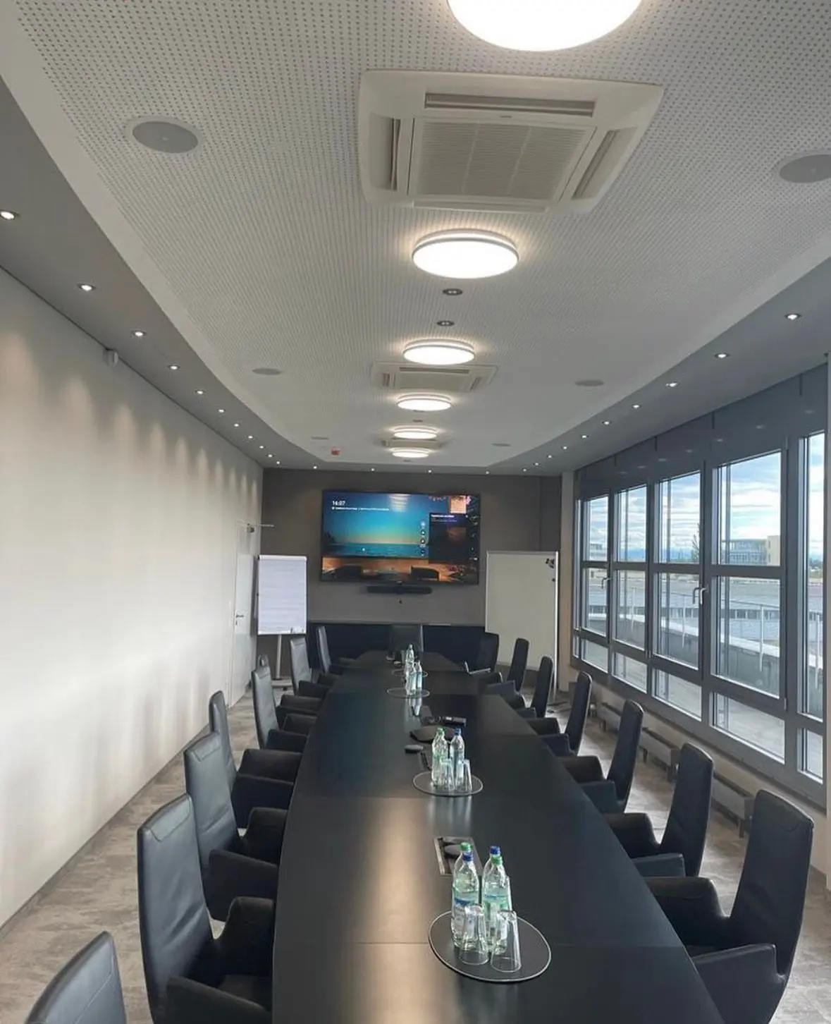 Conference room with a long table and media equipment