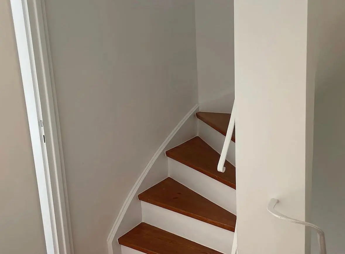 Refurbished timber staircase with a white balustrade