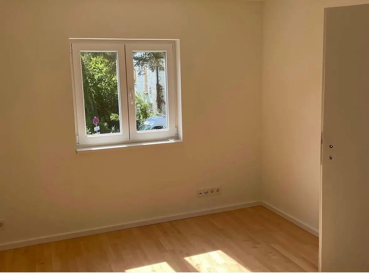 Refurbished room with a new wood floor and window