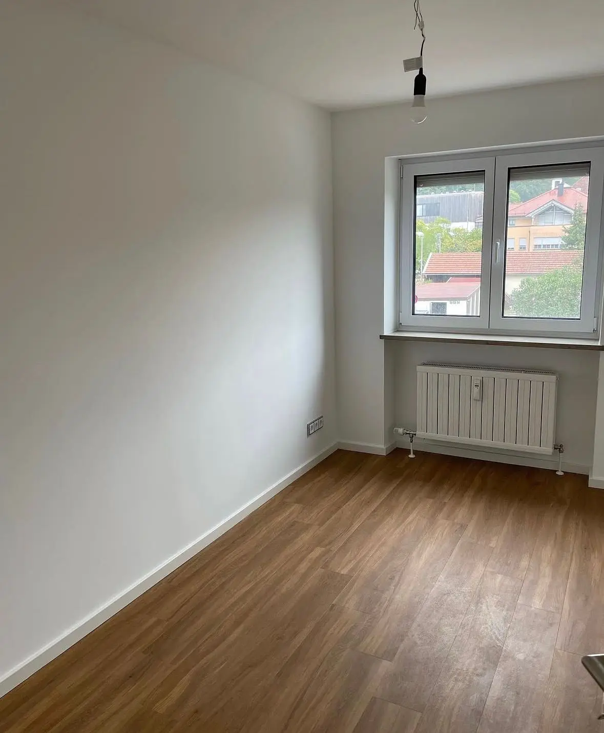 Room with new flooring and a radiator